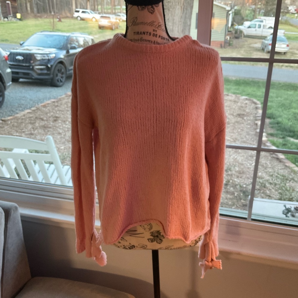 Pink sweater with ties at wrist